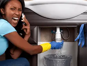 Emergency plumbing repair for a leaking sink drain under a bathroom vanity in Kenosha, WI
