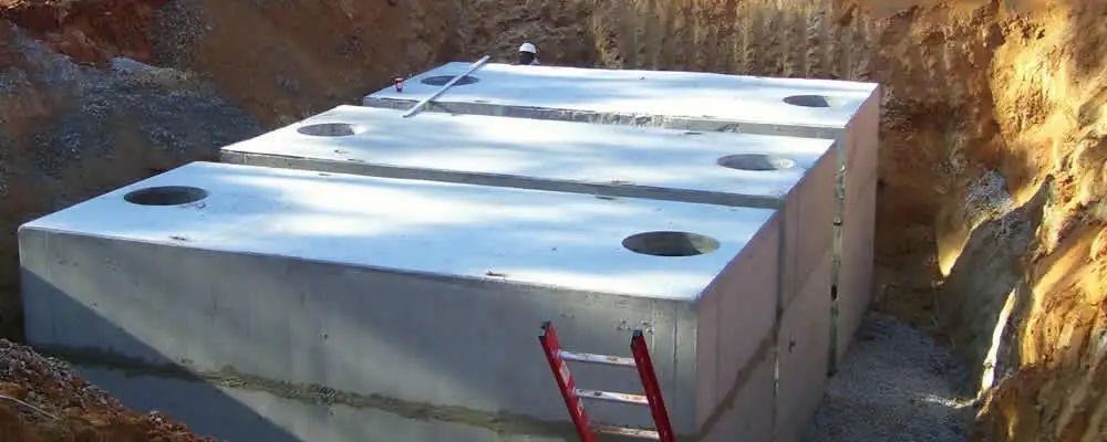 Septic tank installation site with a newly placed concrete tank in Kenosha, WI